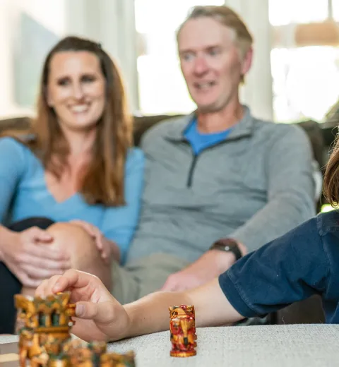 Family Playing Chess in a Clean Home