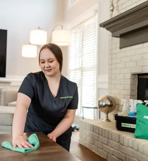 Team Member Dusting Fireplace