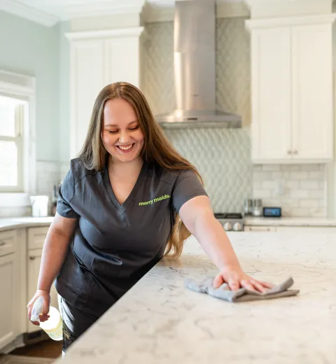 Team Member Cleaning Kitchen Island