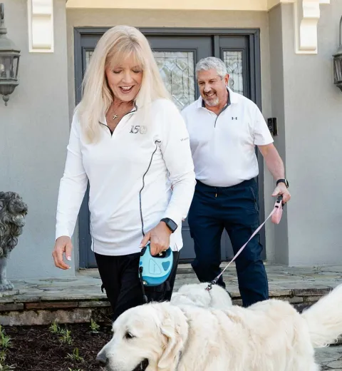 Couple outside home with dog