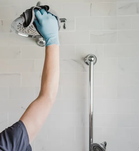 Merry Maids team member cleaning a bathroom.
