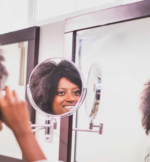 Woman putting on makeup