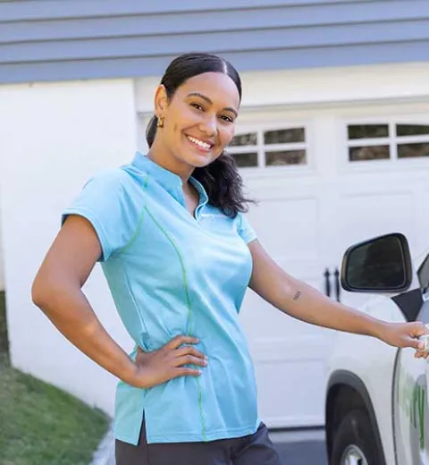 Merry Maids team member by car