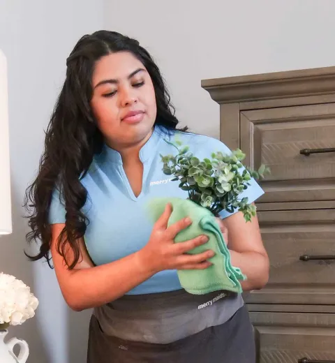 Merry Maids cleaner with vase