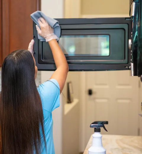 merry maid cleaning a microwave