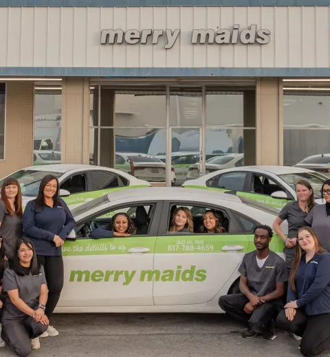merry maids standing in front of a branded vehicle