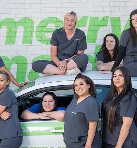 merry maids posing by a branded vehicle