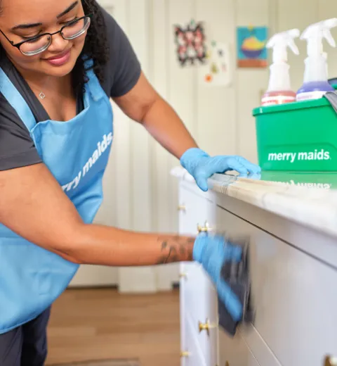 merry maid wiping cabinets