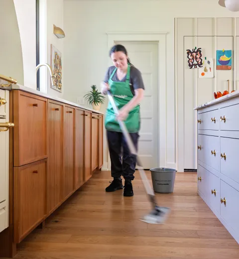 merry maid mopping the floor
