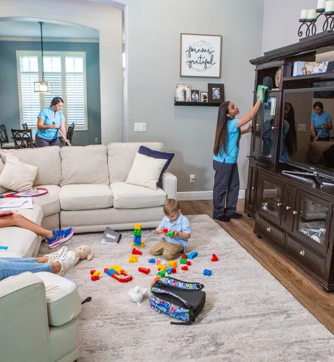 kids playing while Merry Maids clean