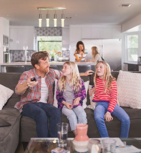 Family gathers on the couch to watch television