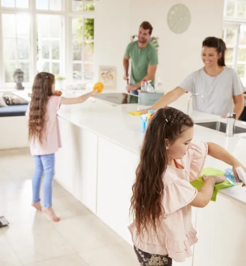 Family of 5 cleaning the kitchen together. | Merry Maids®