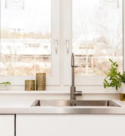 kitchen sink in front of sunny window