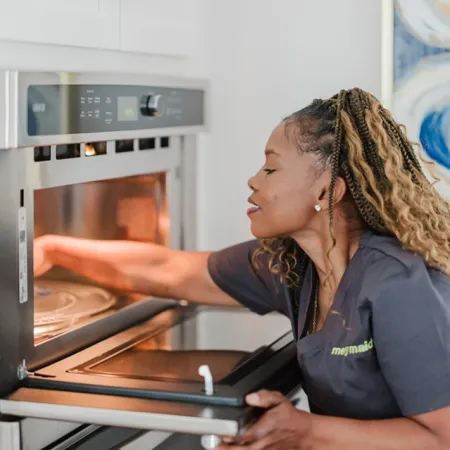 Team Member Cleaning Oven