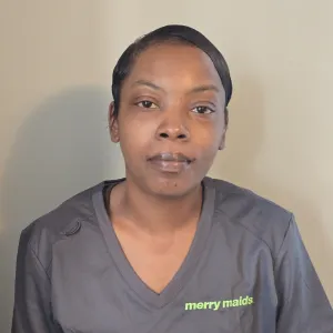 nina is smiling wearing a merry maids uniform