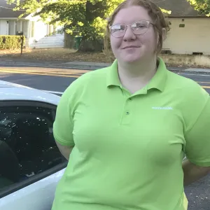 merry maid standing by a branded white vehicle