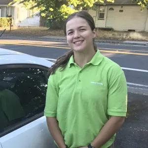 merry maid standing by a branded white vehicle