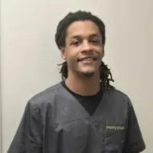 merry maid smiling in front of a tan wall