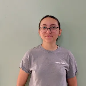 Ella standing in front of a green wall