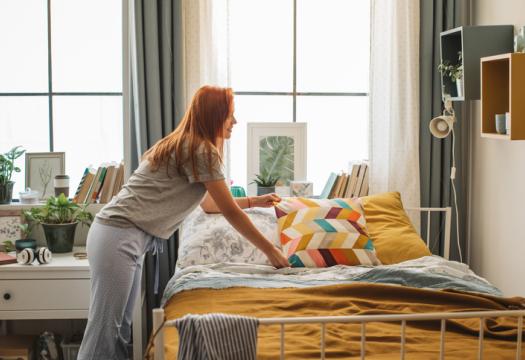 Young girl organizing dorm room | Merry Maids