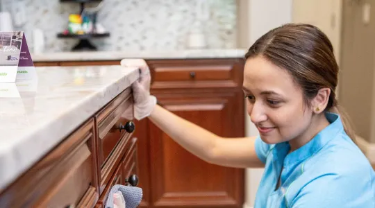 Team member wiping cabinets