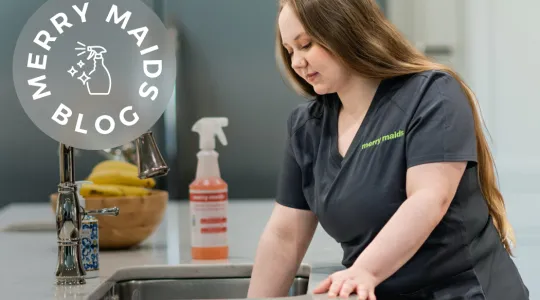 Woman cleaning garbage disposal