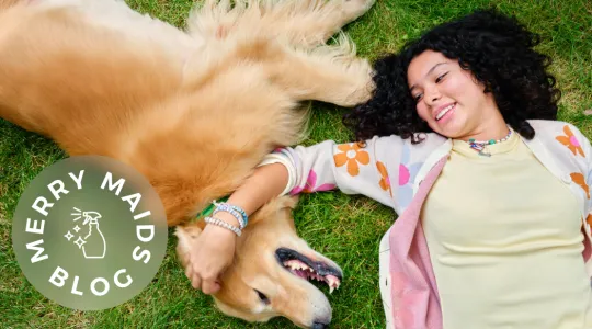 girl and dog in grass