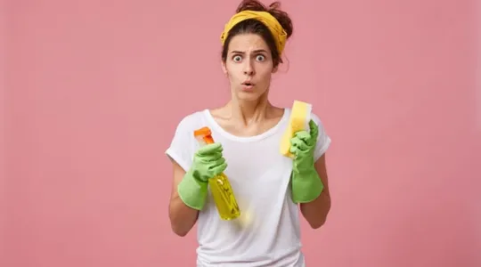 Woman looking stressed holding sponges