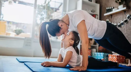 Mom and daughter doing yoga