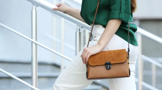 Fashionable lady carrying a leather purse