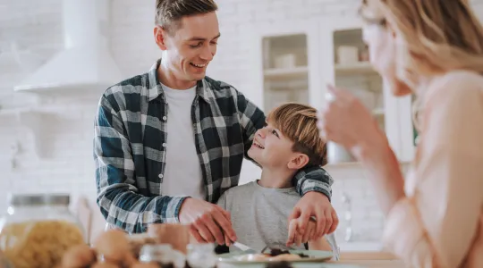 Family Eating Breakfast Together in Kitchen