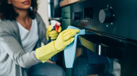 Women cleaning an oven | Merry Maids