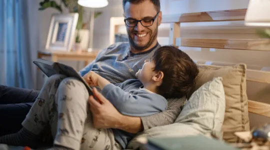 Dad reading bedtime stories to son | Merry Maids