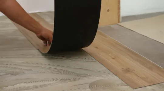 Worker installing new vinyl tile floor | Merry Maids