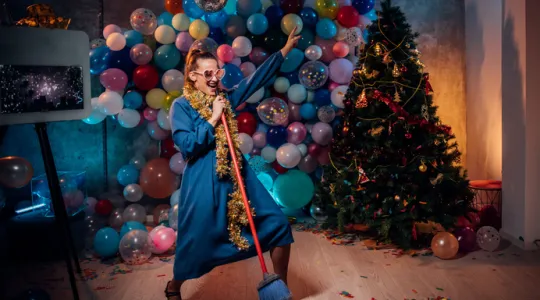 Young woman dancing and cleaning after new year party | Merry Maids