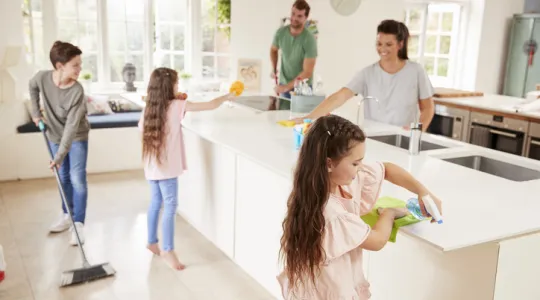 Family of 5 cleaning the kitchen together. | Merry Maids®