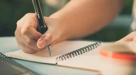 Journaling on a table with tea