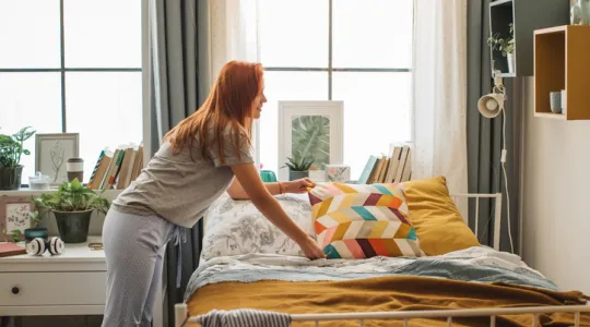 Young girl organizing dorm room | Merry Maids
