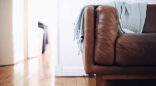 Couch sitting on clean hardwood floors