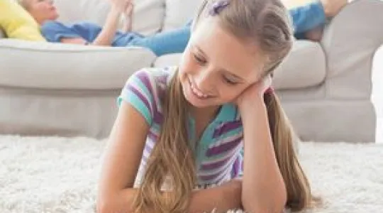 child laying on clean area rug