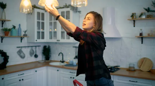 Woman changing lightbulb