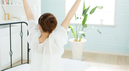 Woman waking up to a clean home after vacation