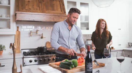 Husband and Wife Cooking Meal Together