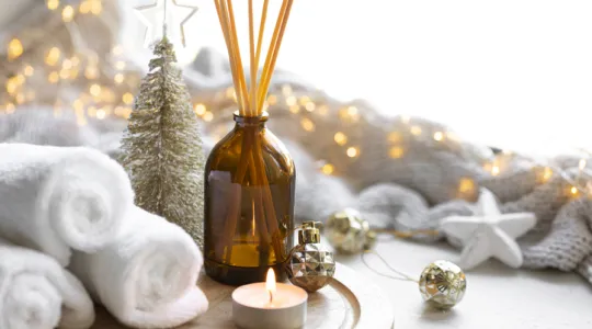 Christmas spa composition with towels, candle and incense sticks | Merry Maids