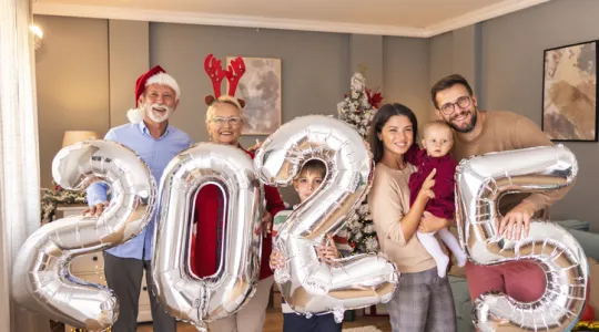 Beautiful happy multi-generation family celebrating Christmas at home. | Merry Maids