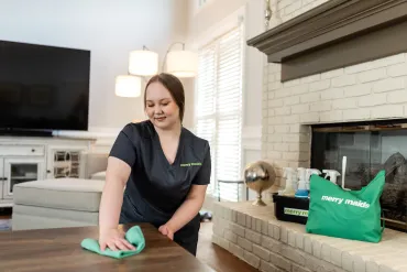 Team Member Dusting Fireplace