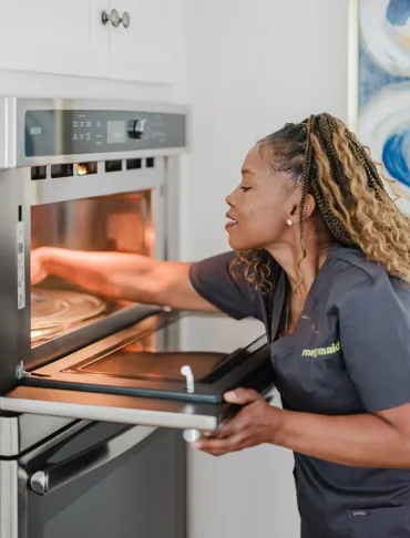 Team Member Cleaning Oven