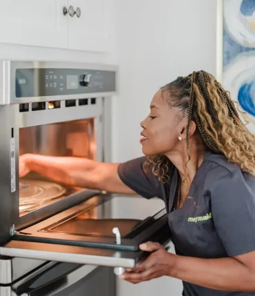 Team Member Cleaning Oven