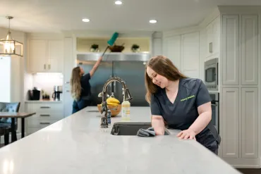 Two Team Members Cleaning Kitchen