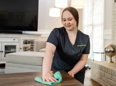 Merry Maids cleaner wiping counters